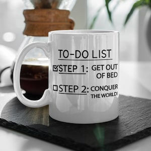 Funny Get Out Of Bed and Conquer The World 11oz Coffee Mug.