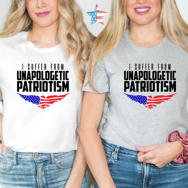 Op de afbeelding: Twee vrouwen dragen witte en grijze T-shirts met de tekst "I suffer from unapologetic patriotism" en een Amerikaans vlaggen-adelaar ontwerp.