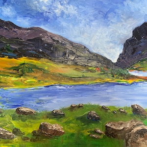 Puede incluir: Una pintura de un lago rodeado de montañas y hierba verde. El lago es de un azul brillante y las montañas son de un gris oscuro. Hay varias rocas en primer plano.