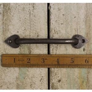 May include: A black metal door handle with a heart-shaped design on each end. The handle is approximately 7.6 cm long. Made in Australia.