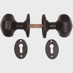 May include: A set of black oval door knobs with matching keyhole covers. The door knobs are oval-shaped and connected by a metal rod. The keyhole covers are also black and oval, with a keyhole cutout and two screw holes.