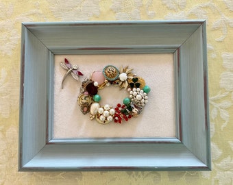 Spring/Summer Floral Wreath on soft white velvet background. 9.5”x7.5”x.75 distressed aqua wood frame. Perfect for table or mantel.