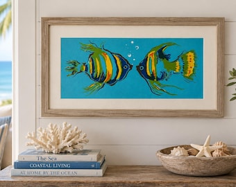 May include: A framed horizontal wall art print featuring two stylized angelfish in shades of yellow, green, and blue against a bright turquoise background, with small white bubbles between them, enclosed in a light brown wood frame with a white mat.