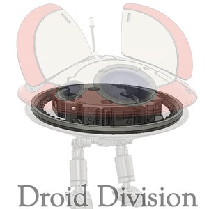 May include: A white and red robot with a round base and two legs. The robot has a clear dome on top and a gear system visible underneath. The text "Droid Division" is printed below the robot.