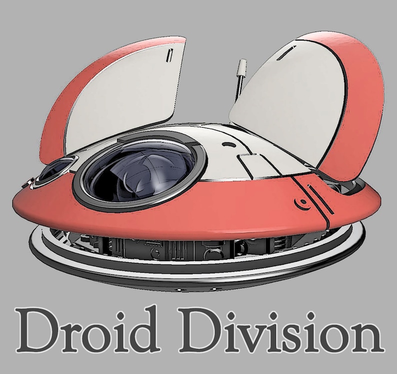 May include: A red and white droid with two open panels and a large lens. The droid is on a grey background with the text "Droid Division" below it.