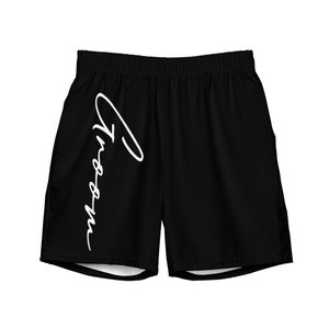 May include: Black athletic shorts with a white signature design that says "The Dream".