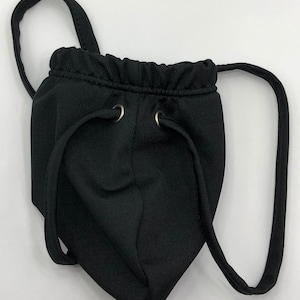 May include: Black pouch with a drawstring closure and two adjustable straps. The pouch has a ribbed texture and two silver metal eyelets.