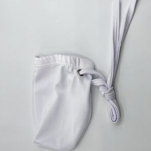 May include: White drawstring pouch with a white cord. The pouch is made of a soft, smooth fabric.