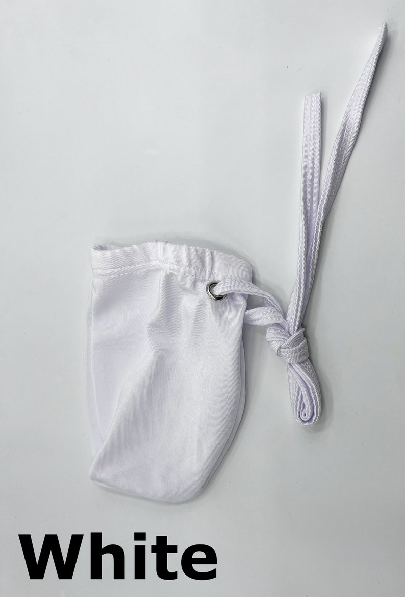 May include: White drawstring pouch with a white cord. The pouch is made of a soft, smooth fabric.