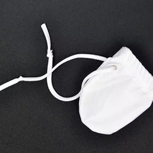 May include: White drawstring pouch with a white cord. The pouch is made of a soft, smooth fabric.