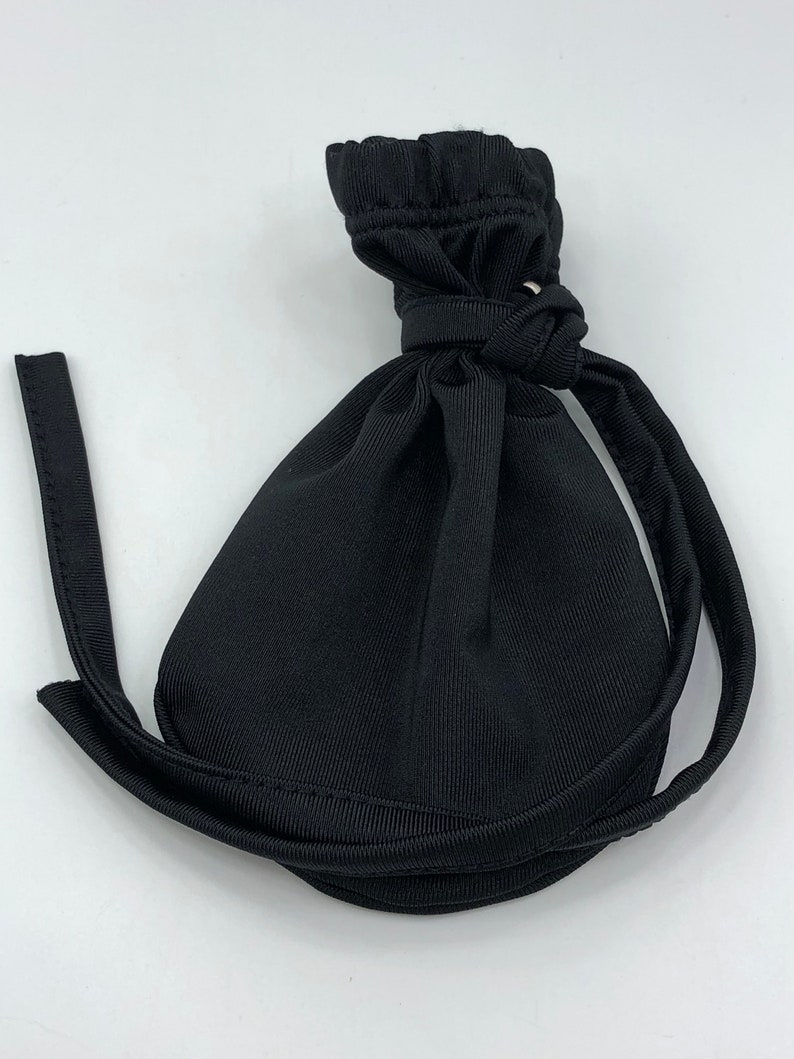 May include: A black drawstring bag with a gathered top and a long, thin strap.
