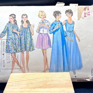 May include: A Butterick 5583 sewing pattern envelope for size 12, bust 34. The front features illustrations of five garments including floral dresses, a skirt and blouse set, a long blue robe, and a sleeveless gown with line drawings on the left.