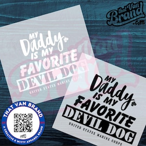 May include: Two white vinyl decals with the text "My Daddy is my Favorite Devil Dog" and "United States Marine Corps". The decals are on a blue wooden surface. The brand logo is also visible.