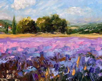May include: An oil painting depicts a vibrant lavender field under a blue sky with fluffy white clouds. In the background, there are green trees, a small village with red-tiled roofs, and rolling hills. The artwork uses thick brushstrokes.