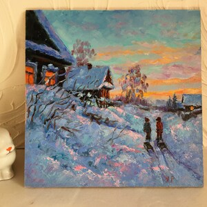 May include: A painting of a snowy winter scene with two figures walking in the distance. The painting features a small wooden house with a lit window, a snow-covered field, and a colorful sunset sky.