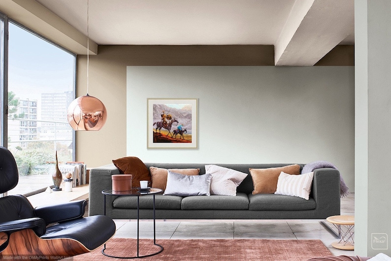 May include: A living room with a gray sofa, a copper pendant light, and a framed painting of two people on horseback. The room has a large window with a view of a city skyline.