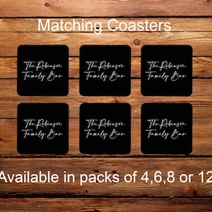 May include: Six black square coasters with white text that reads "The Robinson Family Bar". The coasters are available in packs of 4, 6, 8, or 12.