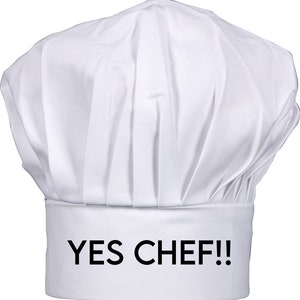 May include: White chef's hat with the text "YES CHEF!!" printed in black on the band.