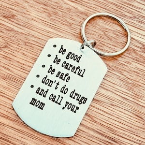 May include: Silver keychain with a tag that reads: "be good, be careful, be safe, don't do drugs, and call your mom".