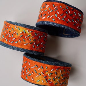 Denim Cuff with Metallic Confetti Embroidery - Blue and Silver Seed Stitching on Red Orange Cotton- and Blue Denim - Embroidered Bracelet