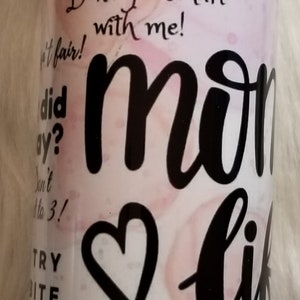 May include: White ceramic mug with a red rim. The mug has a pink and white background with black text and a black heart. The text on the mug reads "horses! What part of I don't... Please... One more bite... Don't get smart with me! ... Did ay? Don't Mo 3! Try bite... It's past your bedtime I've had it up to here! How many times do I tell you? Did you..."