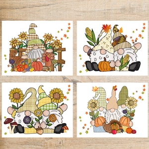 May include: Four fall-themed greeting cards featuring gnome illustrations. Each card showcases gnomes with sunflowers, pumpkins, and autumn leaves. The gnomes wear plaid and patterned hats, with a harvest theme.