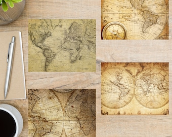 May include: Four vintage world maps with compass, printed on aged paper with brown and yellow tones. The maps are framed and displayed on a wooden surface.