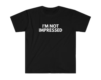 May include: Black t-shirt with the white text "I'M NOT IMPRESSED" across the chest. The shirt has short sleeves and a crew neck. The fabric appears to be a soft, comfortable material.