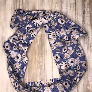 May include: A blue floral headband with white and pink flowers. The headband is made of a soft fabric and is perfect for adding a touch of style to any outfit.