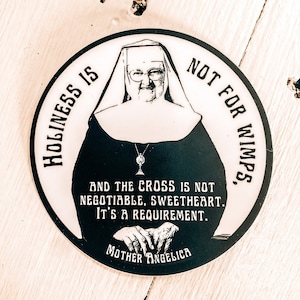 Mother Angelica quote, "Holiness is not for wimps and the cross is not negotiable, sweetheart, it's a requirement.”| Circle Catholic sticker