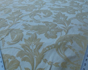 May include: White fabric with a gold floral damask pattern. The fabric has a subtle sheen and a soft texture.