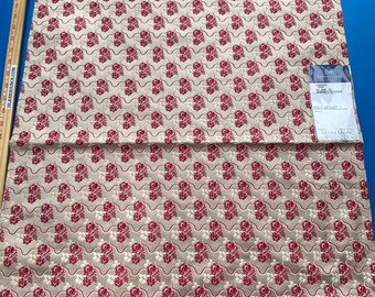 May include: A close-up of a cream-colored fabric with a repeating pattern of red floral designs. The fabric is folded in half and a ruler is placed at the bottom of the image. The ruler reads "SILKRESOURCE.COM THE HOME OF SILK 19 20 21 22 23 24 25 26 27 28 29 30 31 32 33 34 35 36 37 38 39 40 41 42 43 44 45 46 47 48 49 50 51 52 53 54 55 56 57 58 59 60 SILKRESOURCE.COM THE FINEST FABRICS" and "BERK BOX 101".