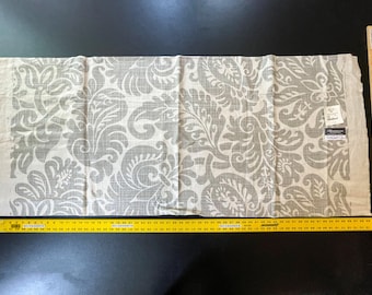 May include: A white fabric with a grey floral pattern. The fabric is approximately 55 inches wide.