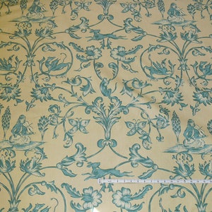 May include: A yellow fabric with a repeating pattern of blue stylized flowers, butterflies, and figures playing musical instruments.