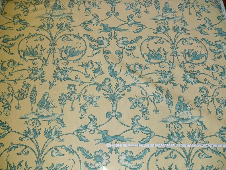 May include: A yellow fabric with a repeating pattern of blue stylized flowers, butterflies, and figures playing musical instruments.