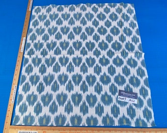 May include: White fabric with a blue and green ikat pattern. The fabric has a label that says "Berk9 Print".