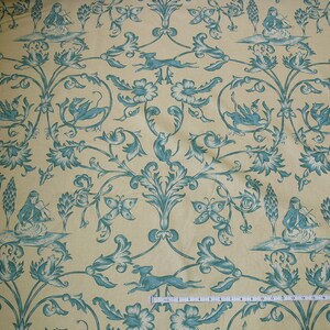 May include: A yellow fabric with a repeating pattern of blue floral designs, butterflies, and figures playing musical instruments.