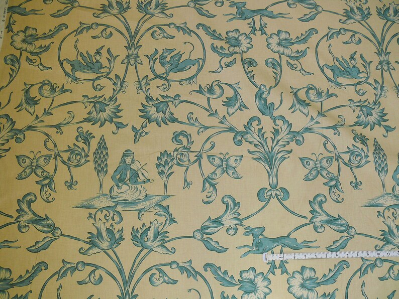 May include: A yellow fabric with a repeating pattern of blue stylized flowers, butterflies, and birds. The pattern is reminiscent of a traditional wallpaper design.