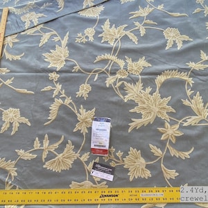 May include: A 2.4 yard piece of blue fabric with a cream floral pattern. The fabric is a crewel, which is a type of embroidery.