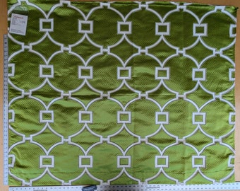 May include: Green fabric with a white geometric pattern of overlapping circles and squares. The fabric has a subtle texture.