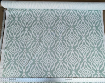 May include: A white fabric with a repeating geometric pattern of green diamonds. The fabric has a subtle linen texture.
