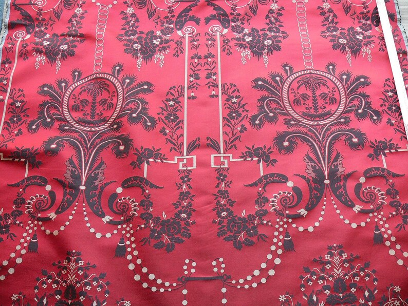 May include: Red fabric with a black and white damask pattern. The pattern features a repeating design of stylized palm trees, garlands, and floral motifs.