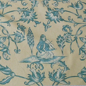 May include: A blue and white floral pattern fabric with a stylized image of a person playing a violin. The person is sitting on a rug with a floral design.