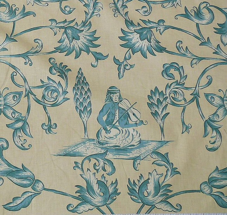 May include: A blue and white floral pattern fabric with a stylized image of a person playing a violin. The person is sitting on a rug with a floral design.