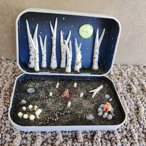 The eyes of the birch trees look on as the witch completes her ritual Altoid diorama.
