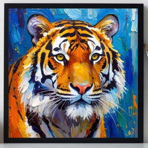 May include: Square framed oil painting of a tiger's face. The tiger has orange and black stripes, yellow eyes, and a pink nose. The background is blue with visible brushstrokes. The painting is in a black frame.