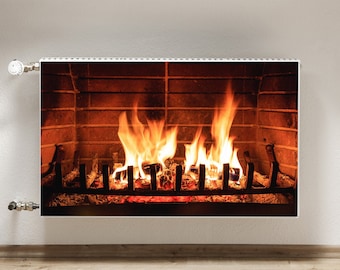 May include: A white electric radiator with a realistic image of a brick fireplace with a roaring fire. The radiator has a silver knob on the left side.