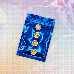 May include: A blue, shiny, resealable bag containing four circular stickers. Each sticker features a smiling sun with a yellow face, a white border, and a brown outline. The stickers are a fun, cheerful design.