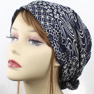 May include: A navy blue and white patterned fabric headband with a knot at the back. The headband is made of a soft, stretchy material and is perfect for keeping hair out of your face.