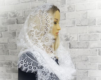 May include: White lace head covering with a delicate floral pattern. The lace is soft and flowing, and the head covering is perfect for special occasions.